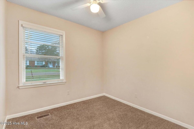 carpeted empty room featuring ceiling fan