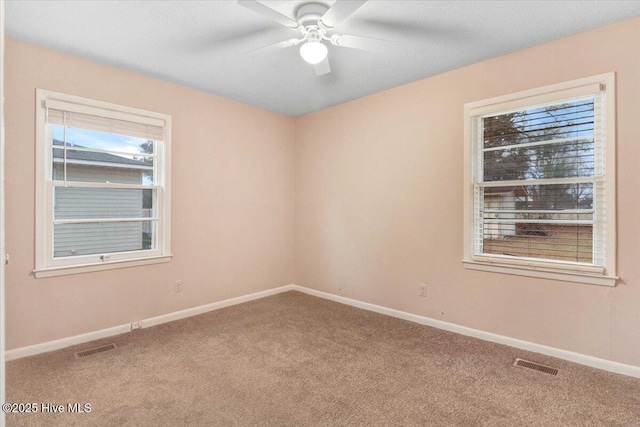 spare room featuring carpet flooring and ceiling fan