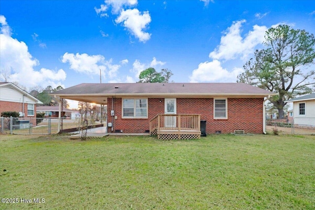 rear view of house featuring a wooden deck, a patio area, and a lawn