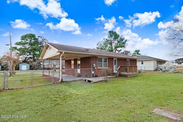 view of front of property with a deck and a front lawn