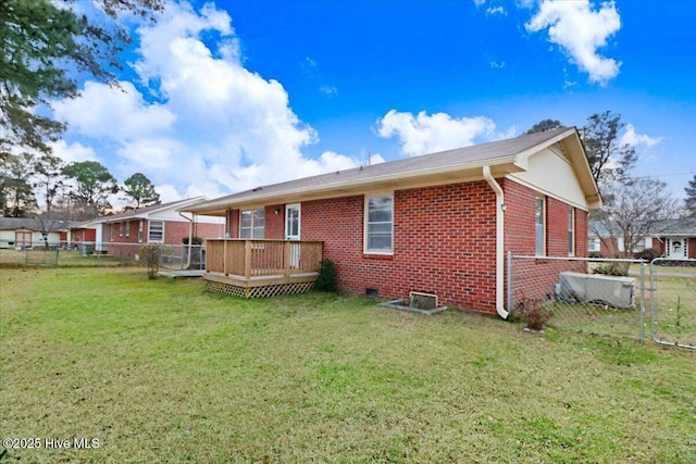 rear view of property with a yard and a deck