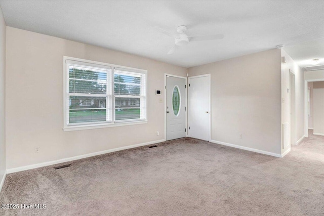 carpeted foyer featuring ceiling fan