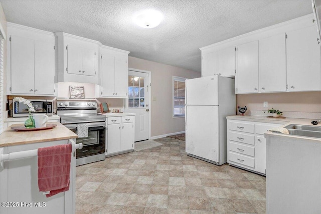 kitchen with stainless steel appliances, sink, a textured ceiling, and white cabinets