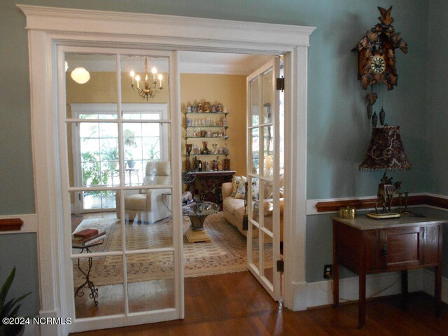 entryway featuring a chandelier and dark wood-type flooring