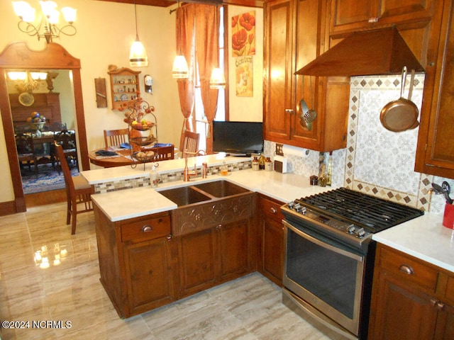 kitchen with sink, kitchen peninsula, pendant lighting, gas range, and premium range hood