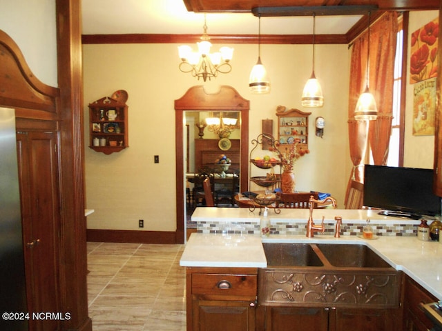 kitchen with an inviting chandelier, sink, light tile patterned floors, and pendant lighting