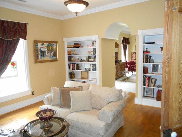 living room featuring ornamental molding and wood-type flooring