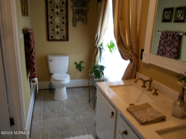 bathroom featuring vanity, toilet, a shower with curtain, and tile patterned flooring