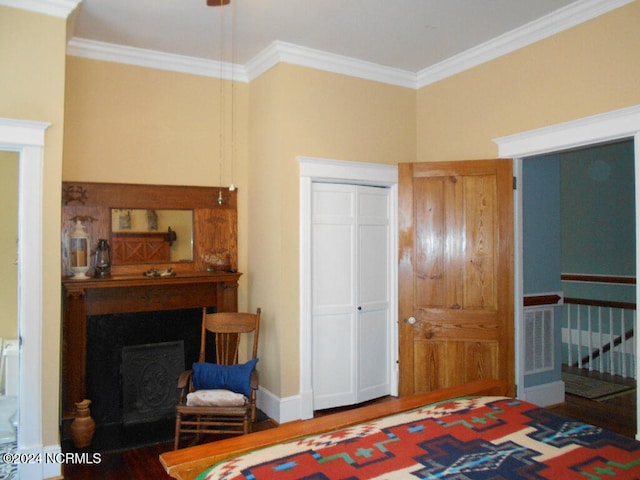 bedroom featuring a closet, crown molding, and hardwood / wood-style flooring