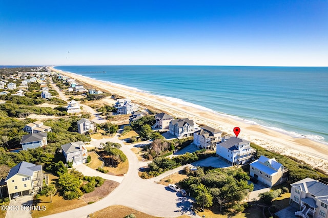 aerial view with a water view and a beach view