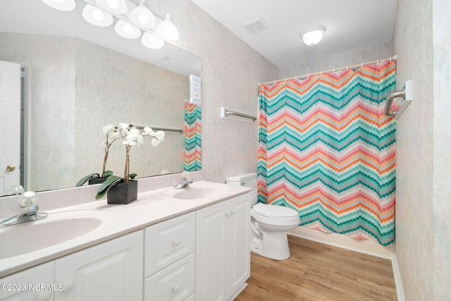 full bathroom with vanity, hardwood / wood-style floors, toilet, and shower / bathtub combination with curtain