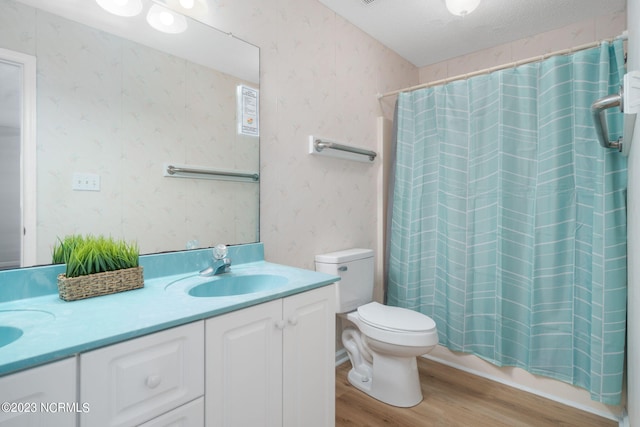 full bathroom with toilet, shower / bath combination with curtain, a textured ceiling, vanity, and hardwood / wood-style flooring