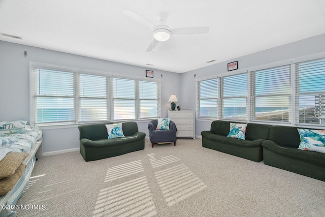 living room featuring carpet flooring and ceiling fan