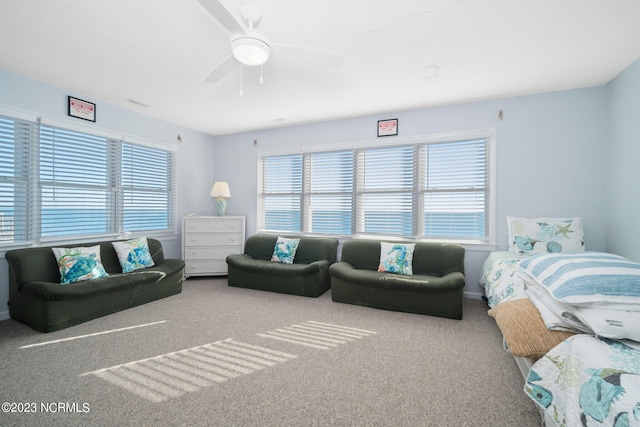 carpeted bedroom with ceiling fan and multiple windows