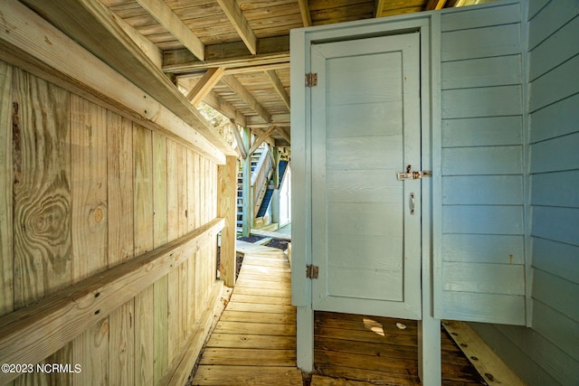 interior space featuring hardwood / wood-style floors and wooden walls