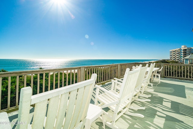 balcony featuring a water view and a view of the beach