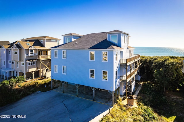 view of property exterior featuring a carport and a water view