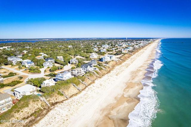 birds eye view of property featuring a view of the beach and a water view