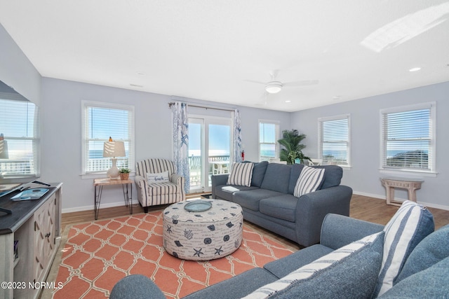 living room featuring hardwood / wood-style floors and ceiling fan