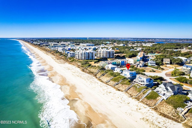 drone / aerial view featuring a water view and a beach view