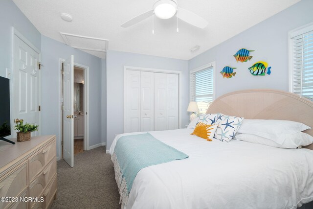 carpeted bedroom featuring a closet and ceiling fan