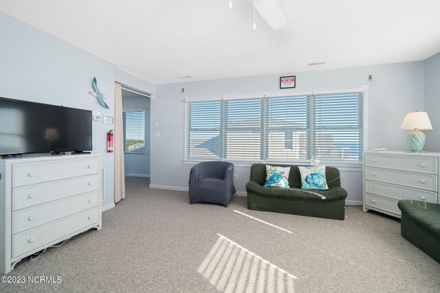 living room with a healthy amount of sunlight, light colored carpet, and ceiling fan