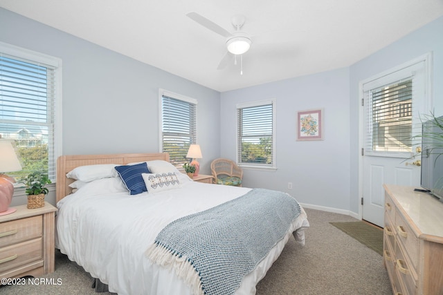 carpeted bedroom featuring multiple windows and ceiling fan