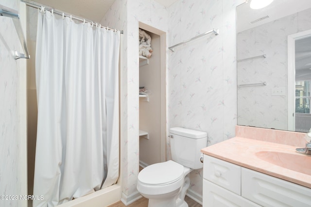 bathroom featuring vanity, toilet, and a shower with curtain