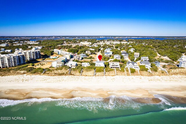 aerial view with a water view and a beach view