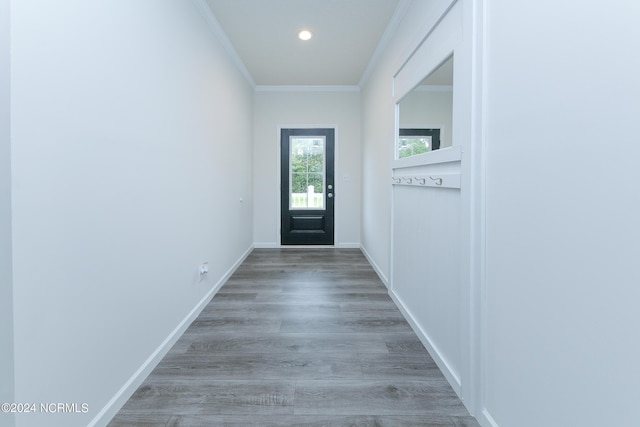 entryway with light wood-type flooring and ornamental molding