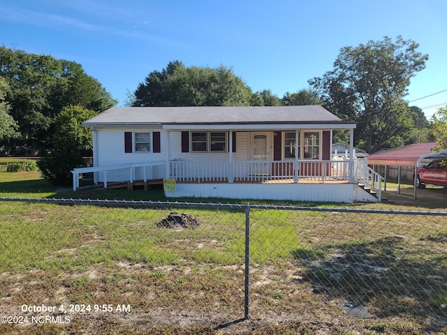 view of front facade with a front yard and a porch