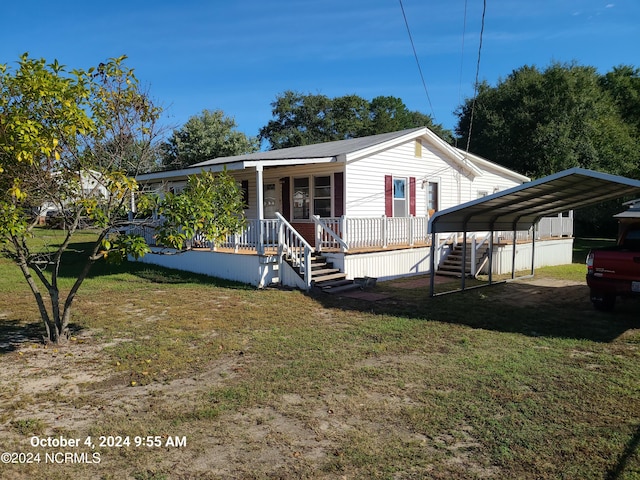 view of front of property featuring a front yard, a carport, and covered porch