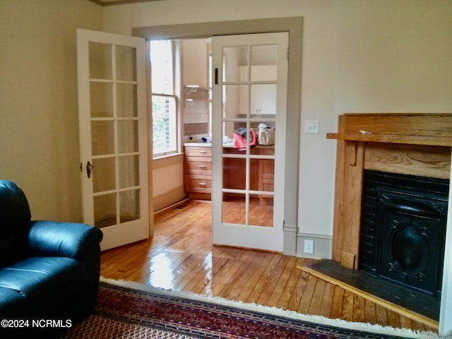 1222 National Ave, New Bern, NC 28560 - living room with french doors, hardwood / wood-style flooring, and a fireplace