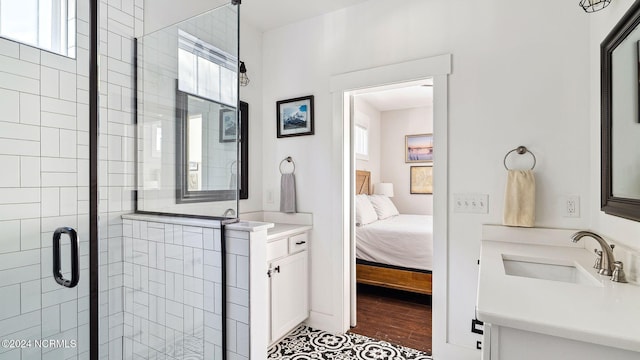 bathroom featuring vanity, a shower with shower door, and wood-type flooring