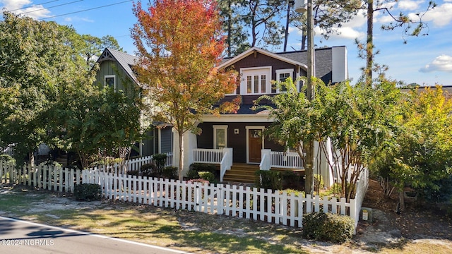 view of front of property featuring a fenced front yard and covered porch