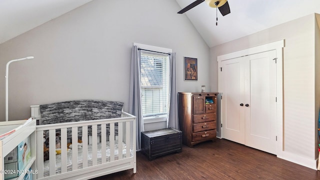 bedroom with dark wood-type flooring, ceiling fan, a closet, and high vaulted ceiling