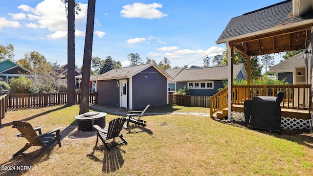 view of yard featuring a deck and a fire pit