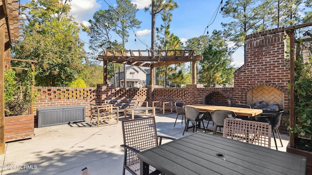 view of patio with outdoor dining space, an outdoor brick fireplace, and a pergola