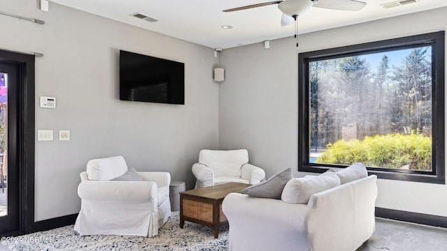 sitting room with visible vents, baseboards, plenty of natural light, and ceiling fan