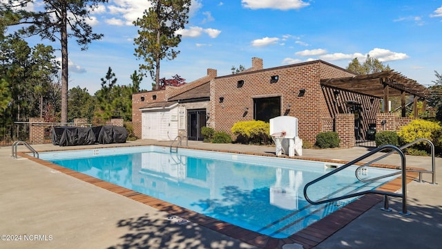 pool with a pergola, fence, and a patio