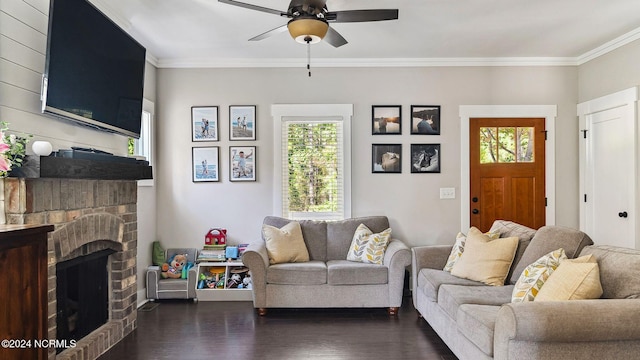 living area featuring a ceiling fan, dark wood finished floors, ornamental molding, and a fireplace