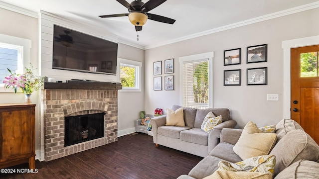 living room featuring ornamental molding, a brick fireplace, dark hardwood / wood-style floors, and a healthy amount of sunlight