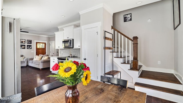 dining room featuring crown molding and dark hardwood / wood-style flooring