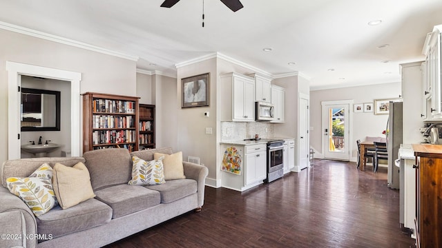 living area with crown molding, recessed lighting, a ceiling fan, and dark wood finished floors