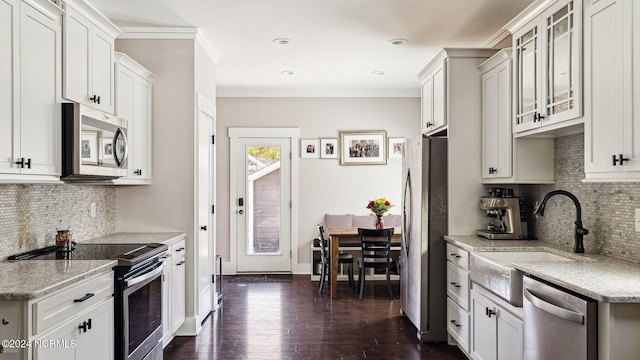 kitchen with white cabinetry, stainless steel appliances, and dark wood-type flooring