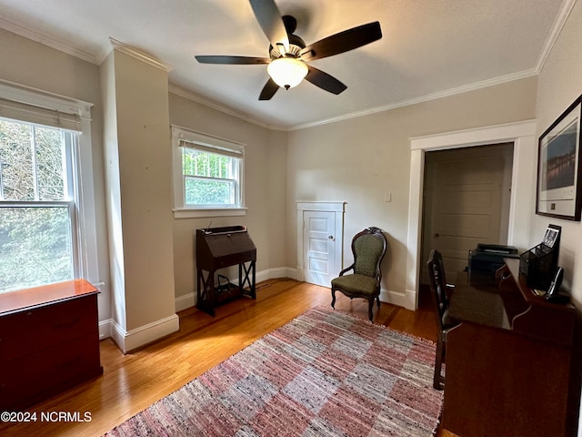 sitting room with wood-type flooring, ceiling fan, and crown molding