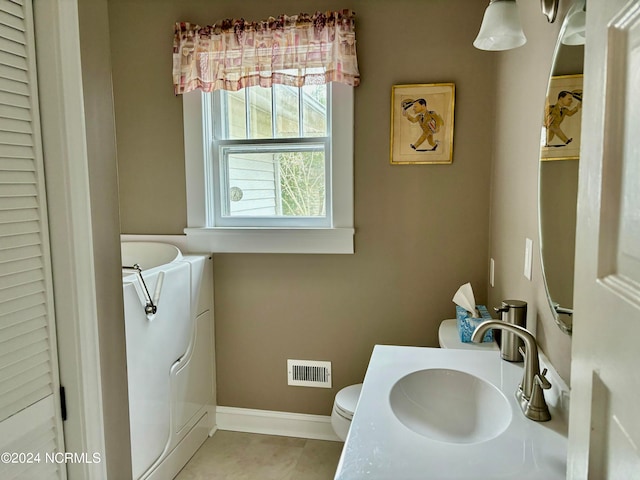 bathroom featuring tile patterned flooring, vanity, and toilet