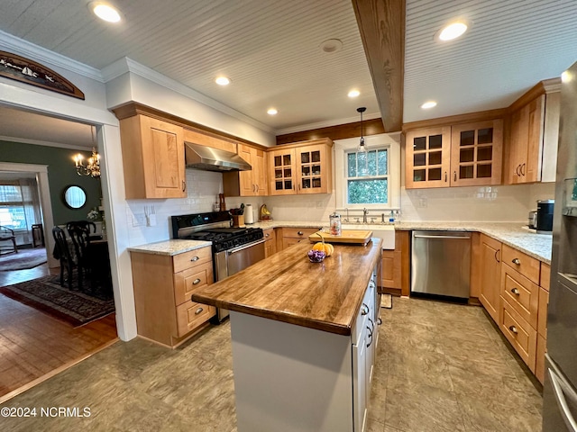 kitchen with appliances with stainless steel finishes, a center island, light hardwood / wood-style flooring, wood counters, and wall chimney range hood