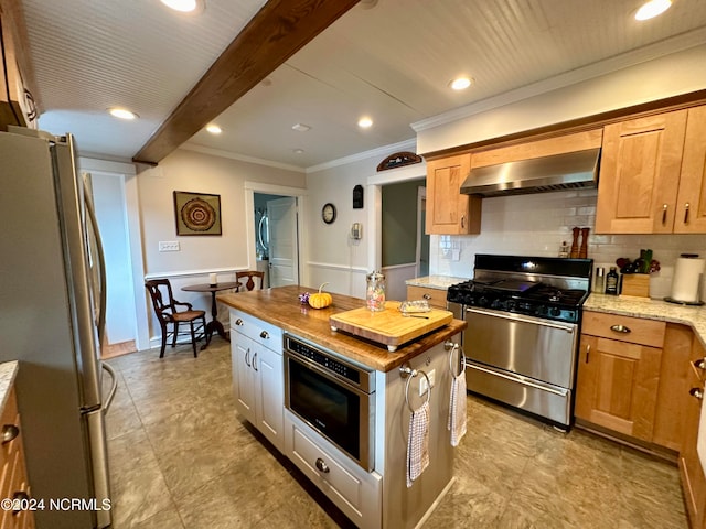 kitchen with appliances with stainless steel finishes, butcher block counters, exhaust hood, beam ceiling, and ornamental molding