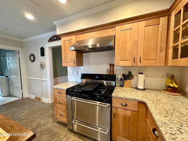 kitchen with backsplash, light stone countertops, gas stove, ornamental molding, and extractor fan